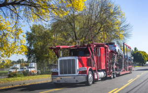 Front View of Red Truck Hauling Cars on the Road