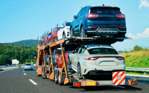 Orange Truck Hauling Cars on the Road